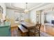 Cozy dining room with natural light, rustic table and bench, and classic chandelier at 2952 Perimeter Cir, Buford, GA 30519