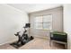 This exercise room features carpet, a window with blinds, and workout equipment at 2952 Perimeter Cir, Buford, GA 30519