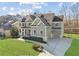 Beautiful two-story home with a lush green lawn, long driveway, and attached two-car garage at 2952 Perimeter Cir, Buford, GA 30519