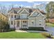 Charming two-story home with a manicured front yard and inviting covered porch with seating area at 2952 Perimeter Cir, Buford, GA 30519