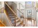Elegant foyer with hardwood floors, staircase, and large windows providing ample natural light at 2952 Perimeter Cir, Buford, GA 30519