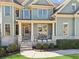 Inviting front porch with brick accents, outdoor seating, and well-manicured landscaping at 2952 Perimeter Cir, Buford, GA 30519
