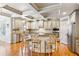 Spacious kitchen with hardwood floors, granite countertops, stainless steel appliances, and coffered ceilings at 2952 Perimeter Cir, Buford, GA 30519