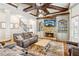 Inviting living room featuring a stone fireplace, built-in shelving, and comfortable seating area at 2952 Perimeter Cir, Buford, GA 30519