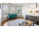 Sunlit living room featuring a blue piano, stylish furniture, and hardwood floors at 2952 Perimeter Cir, Buford, GA 30519