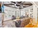 Cozy living room with a stone fireplace, custom ceiling, and large windows with outside views at 2952 Perimeter Cir, Buford, GA 30519