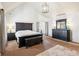 Inviting main bedroom with vaulted ceiling, dark wood furniture, and decorative lighting at 2952 Perimeter Cir, Buford, GA 30519