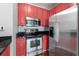 A kitchen with modern stainless steel appliances and red cabinets for a pop of color at 10 Perimeter Summit Ne Blvd # 4312, Atlanta, GA 30319