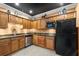 The kitchenette has wood cabinets, granite countertops, stainless steel appliances, and black refrigerator at 10 Perimeter Summit Ne Blvd # 4312, Atlanta, GA 30319