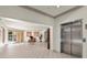Spacious lobby area with elevator, tiled floor, seating, and access to the outside at 10 Perimeter Summit Ne Blvd # 4312, Atlanta, GA 30319