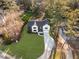 Aerial view of a modern home with lush landscaping, a large front yard and a curving driveway at 198 Johnson Ferry Nw Rd, Atlanta, GA 30328