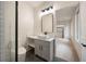 Well-lit bathroom with modern vanity, toilet, shower, and doorway to the closet at 198 Johnson Ferry Nw Rd, Atlanta, GA 30328