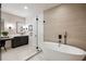 Bathroom with a standalone tub, a glass-enclosed shower, and a modern vanity at 198 Johnson Ferry Nw Rd, Atlanta, GA 30328