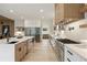 Modern kitchen featuring stainless appliances, wine fridge, and a large center island at 198 Johnson Ferry Nw Rd, Atlanta, GA 30328