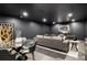 Spacious living room with sleek gray furnishings and decor, with a glass table and modern artwork at 198 Johnson Ferry Nw Rd, Atlanta, GA 30328