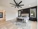 Main bedroom featuring a large window, accent wall, ceiling fan, and hardwood floors at 198 Johnson Ferry Nw Rd, Atlanta, GA 30328