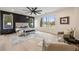 Spacious main bedroom with a large window, accent wall, ceiling fan, and seating area at 198 Johnson Ferry Nw Rd, Atlanta, GA 30328