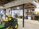 Spacious basement with exposed beams, suitable for storage and equipped with a John Deere tractor at 2870 Whiteview Nw Dr, Acworth, GA 30101