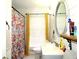 Bright bathroom with floral shower curtain, patterned tile floor, and decorative mirror, a classic design at 2870 Whiteview Nw Dr, Acworth, GA 30101