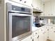 Stainless steel oven with a cooktop featuring white cabinets and light countertops in a kitchen at 2870 Whiteview Nw Dr, Acworth, GA 30101