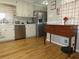 Well-lit kitchen with stainless steel appliances, white cabinets, hardwood floors, and classic decor at 2870 Whiteview Nw Dr, Acworth, GA 30101