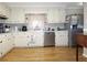 Bright kitchen featuring white cabinetry, stainless steel appliances, and hardwood flooring at 2870 Whiteview Nw Dr, Acworth, GA 30101