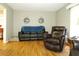 Spacious living room with hardwood floors, a plush couch and comfortable leather chair with bright, natural light at 2870 Whiteview Nw Dr, Acworth, GA 30101