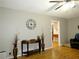 Bright living room featuring hardwood floors, a decorative clock on the wall and stylish vases at 2870 Whiteview Nw Dr, Acworth, GA 30101