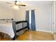 Relaxing main bedroom with rustic wooden bed frame and hardwood floors with fan at 2870 Whiteview Nw Dr, Acworth, GA 30101