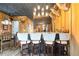 This home bar area features wooden cabinets, counter seating, and wood-paneled walls at 8710 Little Mill Rd, Cumming, GA 30041