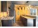 Home bar with wooden cabinets, countertop, stainless steel appliances, and ample storage at 8710 Little Mill Rd, Cumming, GA 30041