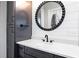 Close up of a bathroom vanity with shaker cabinets, quartz counters, and round mirror at 8710 Little Mill Rd, Cumming, GA 30041