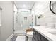 Bright bathroom featuring a glass shower door, marble tile surround, and patterned tile floors at 8710 Little Mill Rd, Cumming, GA 30041