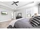 Comfortable bedroom with a tray ceiling, ceiling fan, and large window for natural light at 8710 Little Mill Rd, Cumming, GA 30041