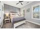 Beautiful bedroom features paneled accent wall, ceiling fan, and plenty of natural light at 8710 Little Mill Rd, Cumming, GA 30041