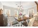 Upstairs dining area boasting a decorative chandelier, hardwood floors, and views of the wooded property at 8710 Little Mill Rd, Cumming, GA 30041