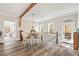 Dining area featuring hardwood floors, views of the backyard, and a staircase leading down to another floor at 8710 Little Mill Rd, Cumming, GA 30041