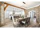 Dining area with a view to an open kitchen, featuring white cabinetry and modern appliances at 8710 Little Mill Rd, Cumming, GA 30041