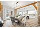 Dining area with open kitchen, complete with modern appliances, a large island, and a view of the backyard at 8710 Little Mill Rd, Cumming, GA 30041