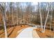 View of the driveway leading to the property's gate and surrounding landscape at 8710 Little Mill Rd, Cumming, GA 30041