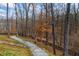 Winding gravel driveway leading through a wooded area, creating a private and picturesque entrance to the property at 8710 Little Mill Rd, Cumming, GA 30041