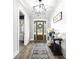 Inviting entryway with wood floors, statement lighting, and charming decor accents at 8710 Little Mill Rd, Cumming, GA 30041