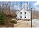 Side view of a modern farmhouse, showcasing the well-maintained landscaping and architectural details at 8710 Little Mill Rd, Cumming, GA 30041