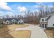 Beautiful white farmhouse with a three car garage and long driveway at 8710 Little Mill Rd, Cumming, GA 30041
