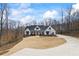 Charming white farmhouse with black trim and a landscaped front yard at 8710 Little Mill Rd, Cumming, GA 30041