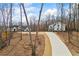 Beautiful farmhouse-style home with a long driveway and detached garage on a spacious lot at 8710 Little Mill Rd, Cumming, GA 30041
