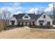 Stunning white farmhouse with black framed windows and well-kept landscaping at 8710 Little Mill Rd, Cumming, GA 30041