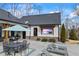 Backyard patio area with outdoor tv, dining, and lounge seating, perfect for entertaining at 8710 Little Mill Rd, Cumming, GA 30041