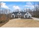 Beautiful white farmhouse with dark accents and well-manicured landscaping at 8710 Little Mill Rd, Cumming, GA 30041