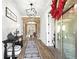 Stylish foyer with wood floors, shiplap walls, brick archway, and view to the dining room at 8710 Little Mill Rd, Cumming, GA 30041